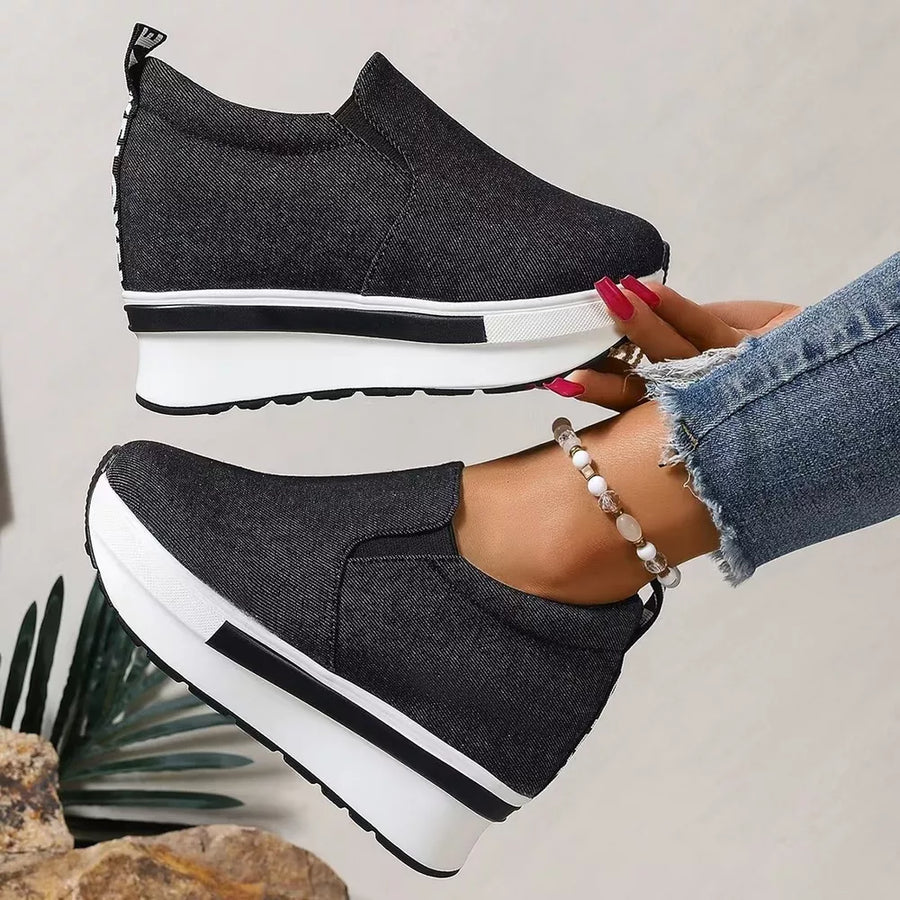 Chic black round-toe slip-on platform shoes with a chunky sole.