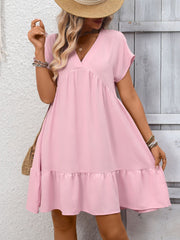 Pink V-neck mini dress with short sleeves and a ruffled hem.