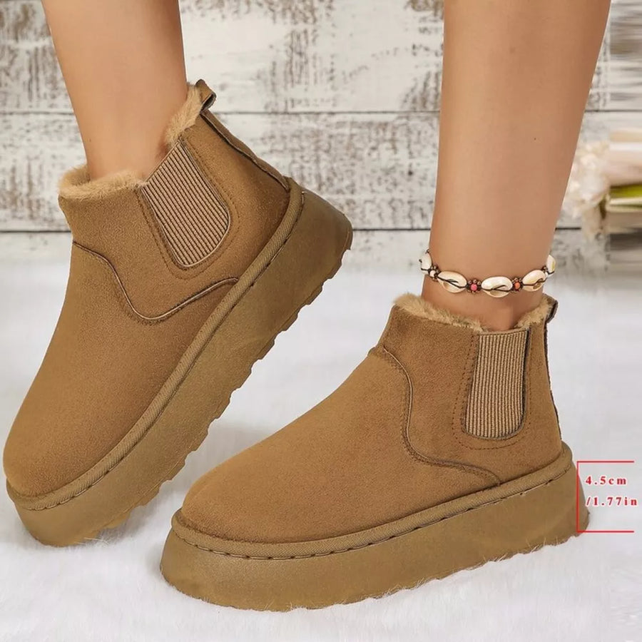 Caramel suede round toe platform ankle boots with faux fur lining and elastic side panels.