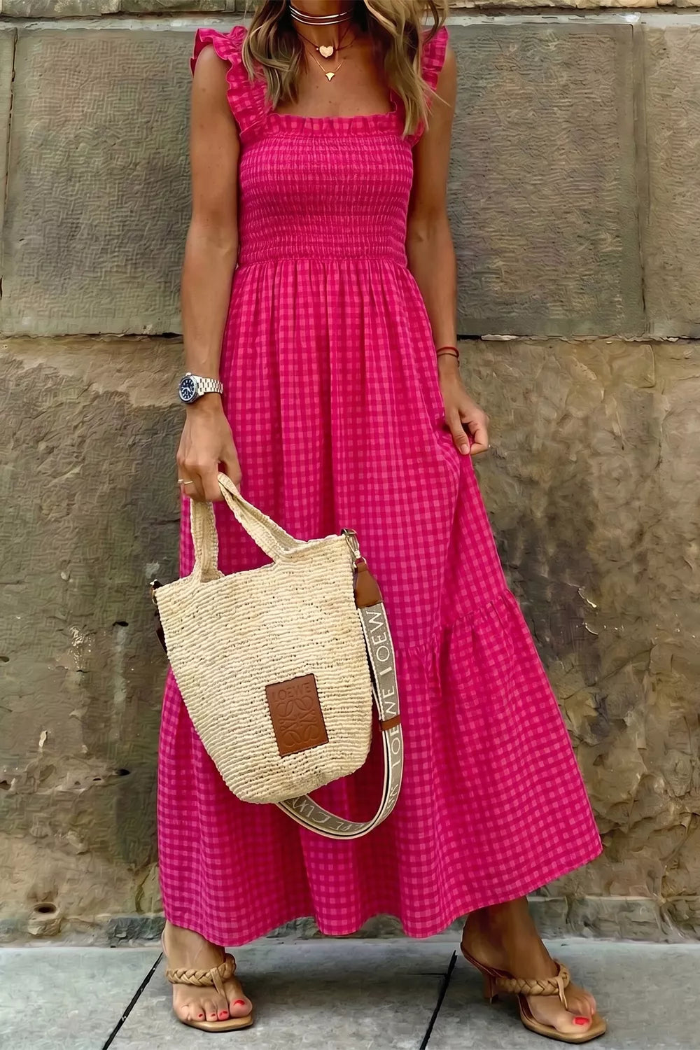 Charming pink gingham cotton sundress with smocked bodice and ruffled straps.