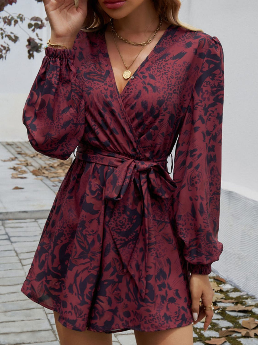 Floral wrap romper in dark brown with blouson sleeves and tie waist