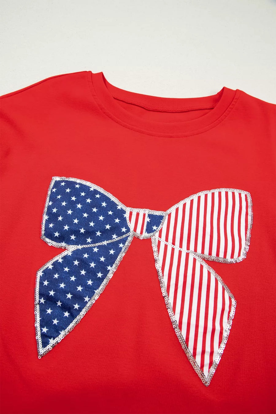 Red cotton dress with a sequined American flag bow detail.