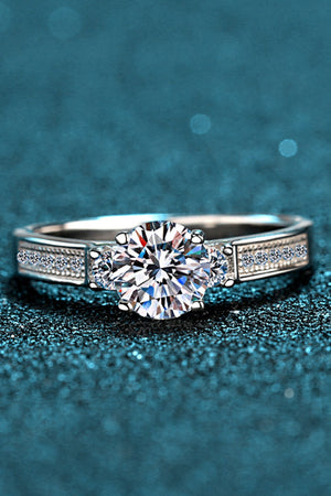 Silver rhodium engagement ring with pavé band and solitaire center stone.