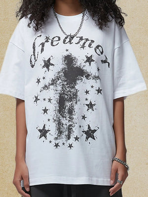 White graphic t-shirt with black "dreamer" text and a distressed figure surrounded by stars.
