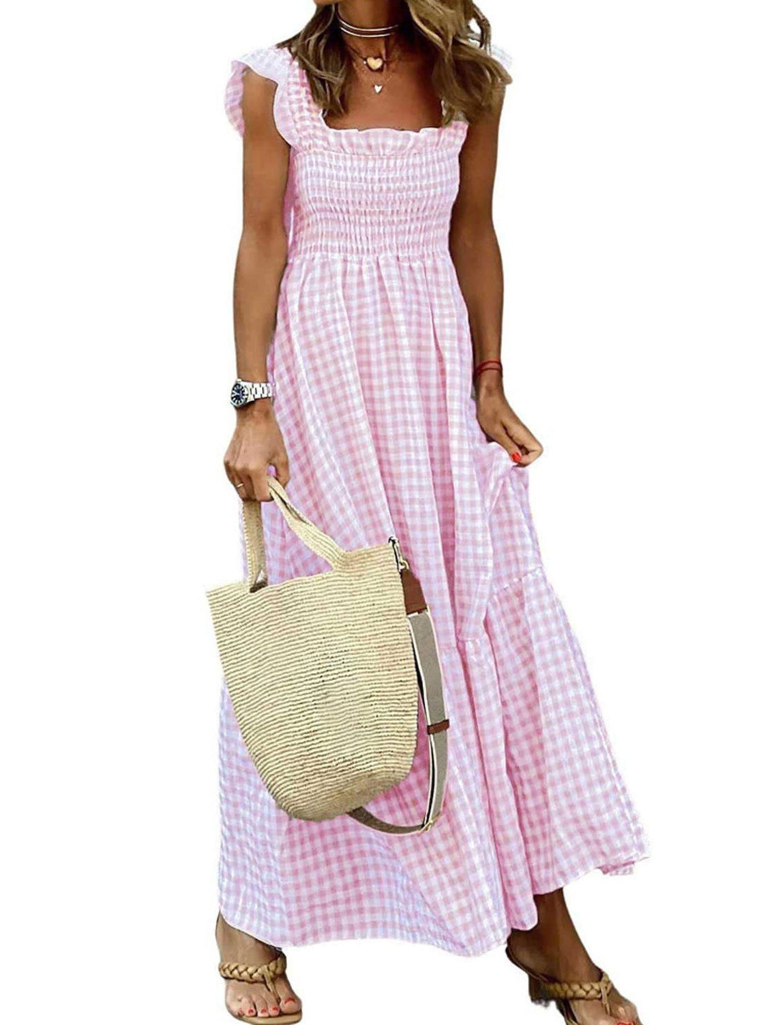 Pink gingham midi dress with smocked bodice, ruffled sleeves, and tiered skirt.