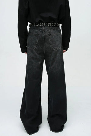 Faded panel wide-leg denim jeans in dark wash with frayed hems.