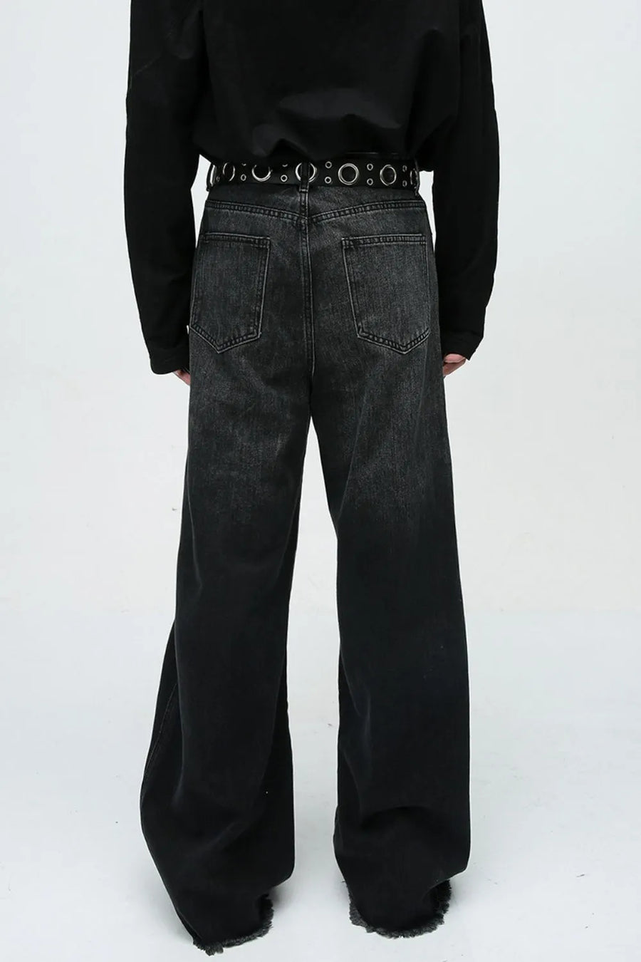 Faded panel wide-leg denim jeans in dark wash with frayed hems.