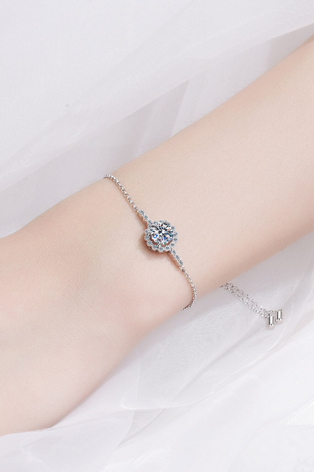 Silver adjustable bracelet with a central round diamond and halo detail