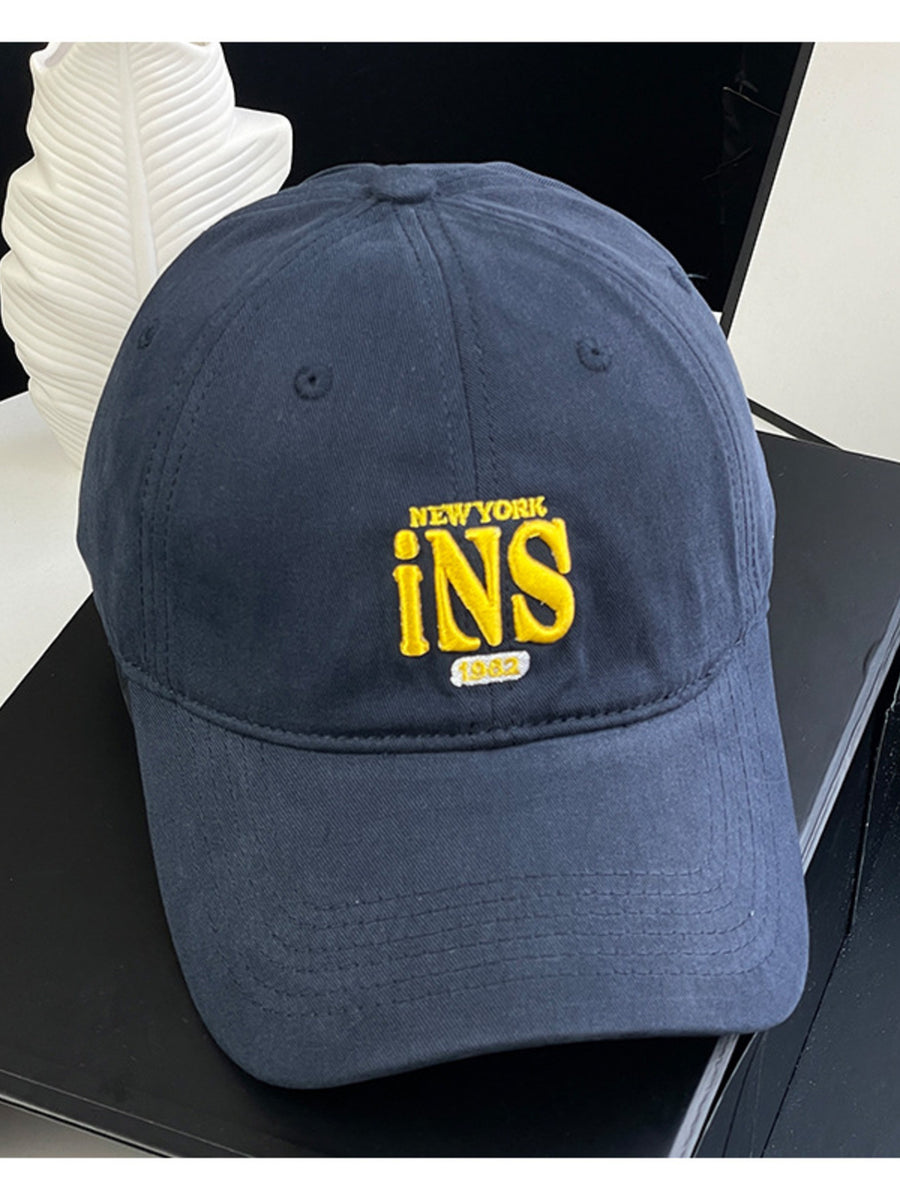 Navy baseball cap with yellow New York INS 1982 embroidery