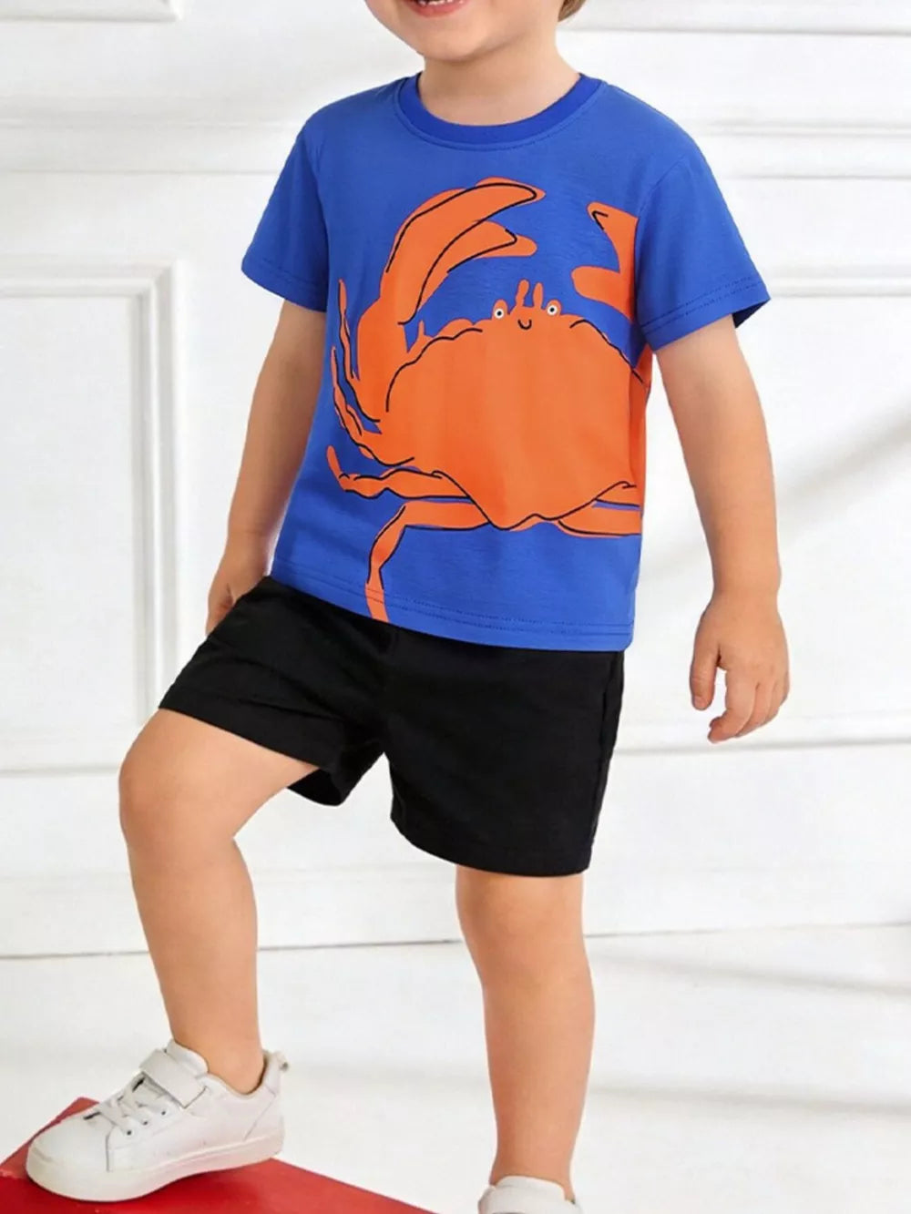 Blue cotton t-shirt with playful orange crab graphic and short sleeves for toddlers.