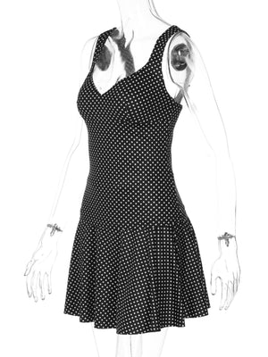 Black and white polka dot mini dress with V-neck and flared skirt.
