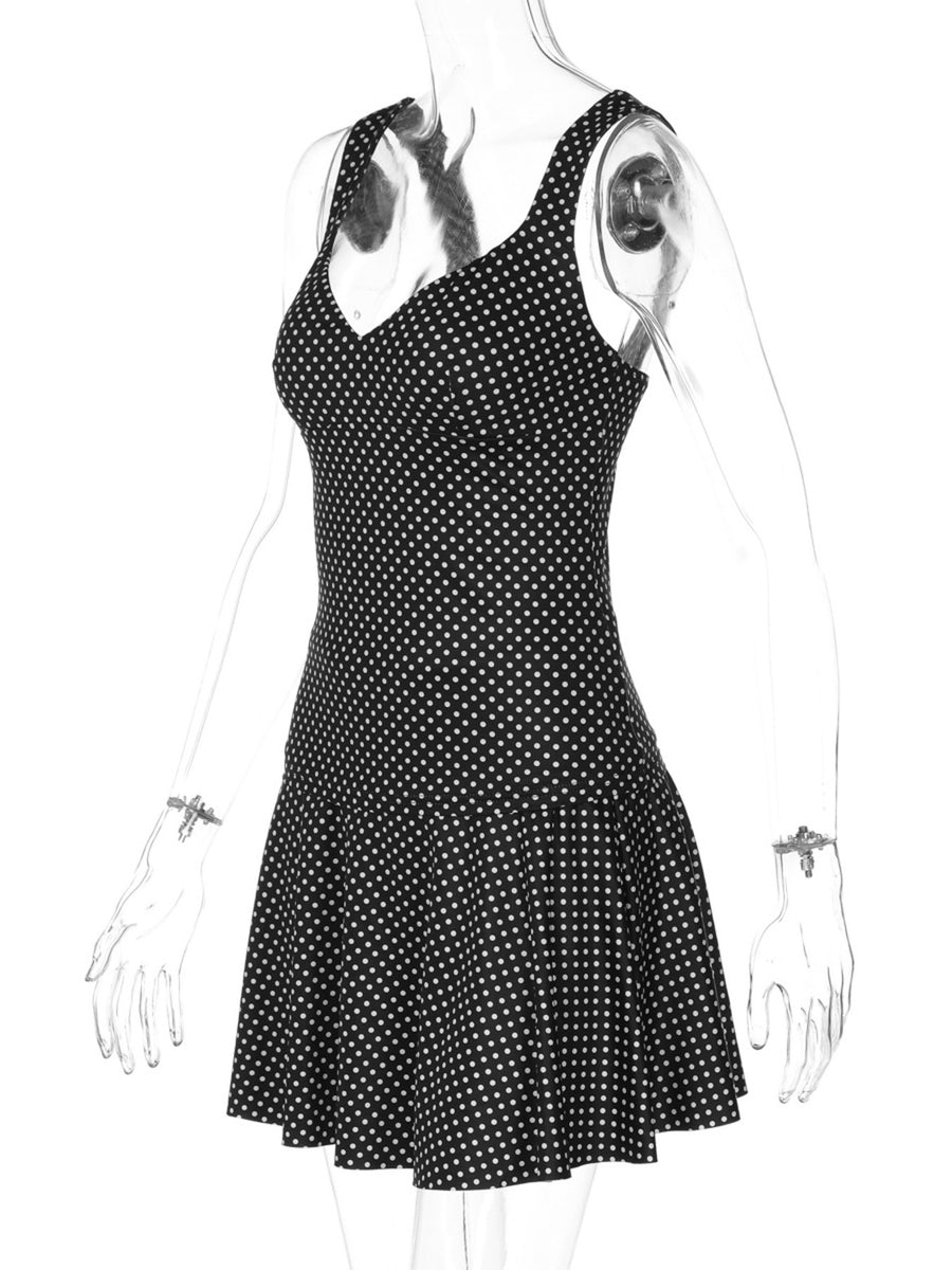 Black and white polka dot mini dress with V-neck and flared skirt.