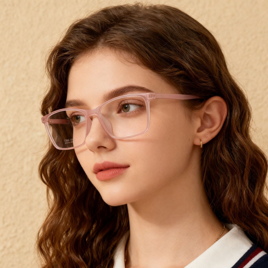 Blush pink square optical glasses with clear lenses on a woman.