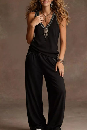 Black V-neck tank top with embroidered trim and wide-leg pants with elastic waist