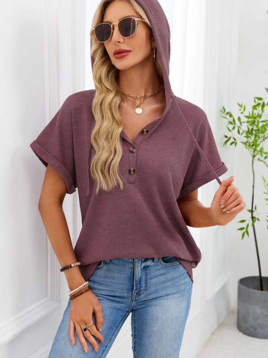 Waffle knit hooded top in brick red with short sleeves and button placket.