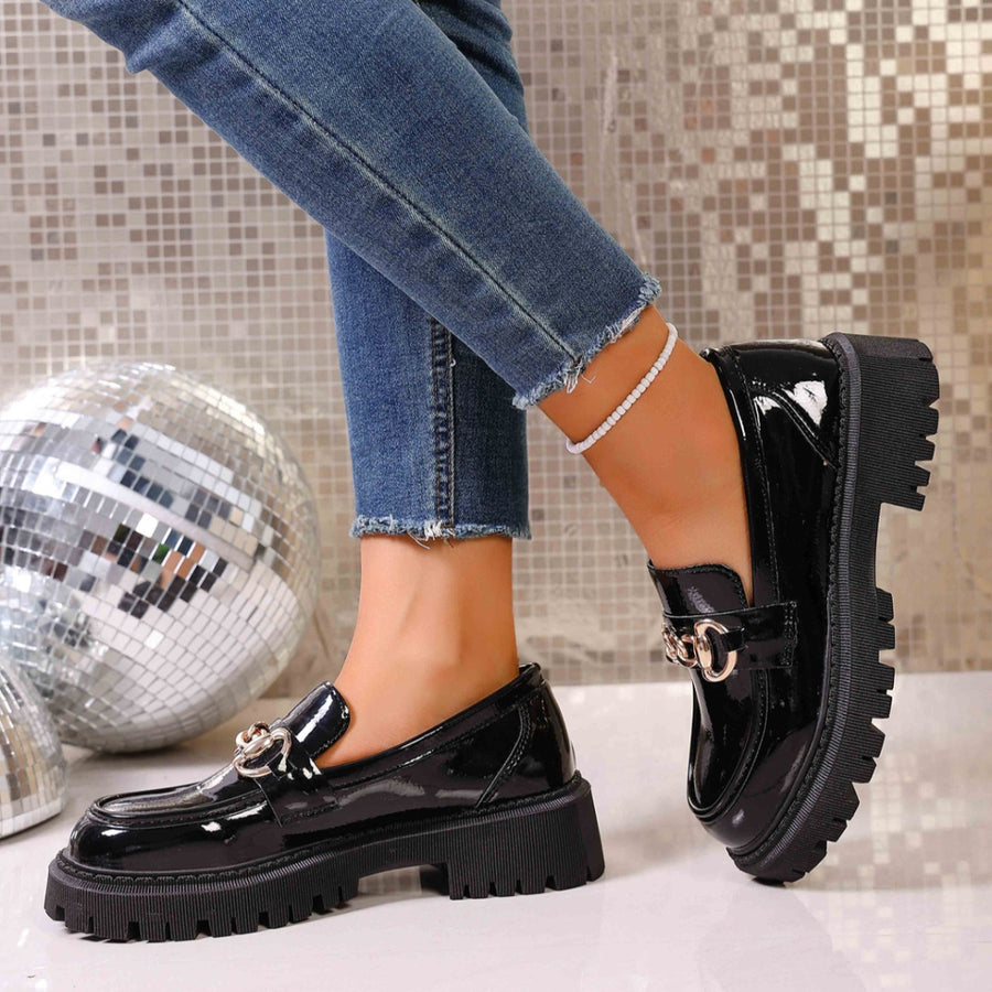 Chunky lug sole loafers in gloss black with gold chain detail and thick platform sole.