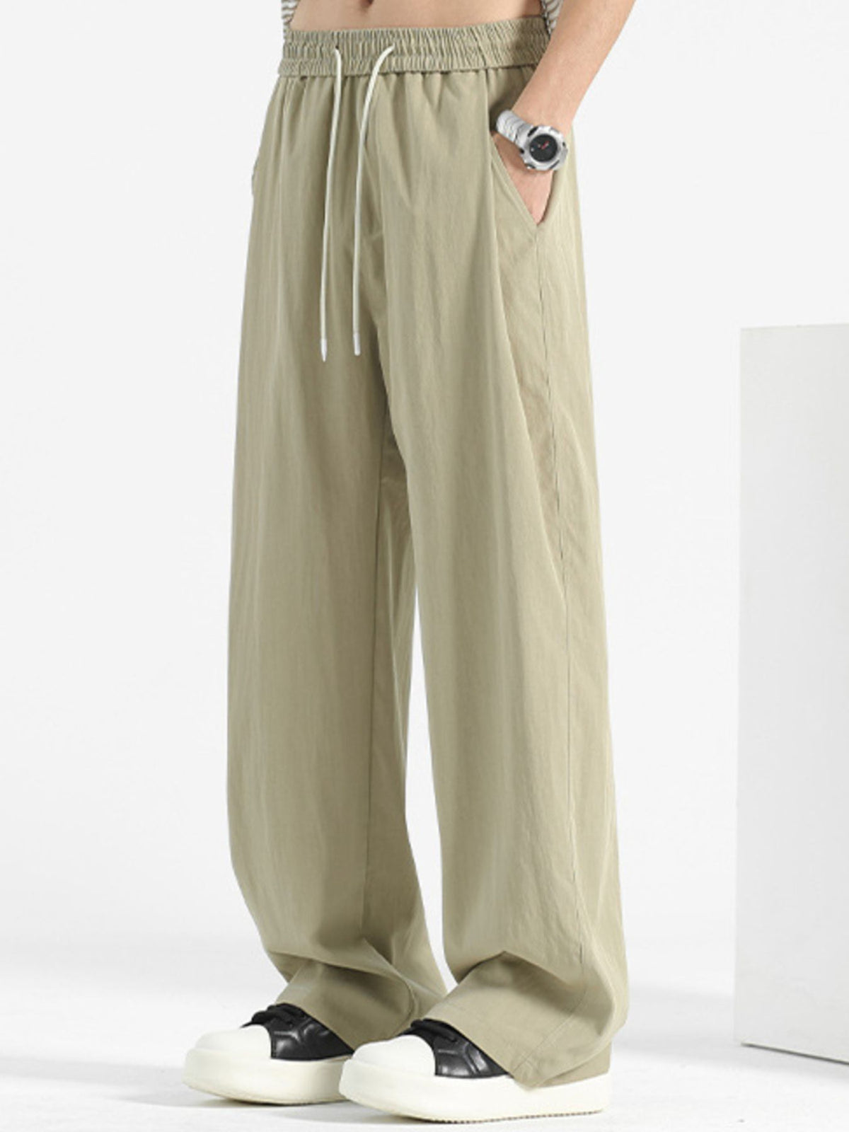 Plus-size sage sweatpants with loose fit, elastic waistband, and drawstring.