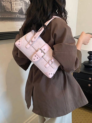 black shoulder bag featuring buckle detail and leopard