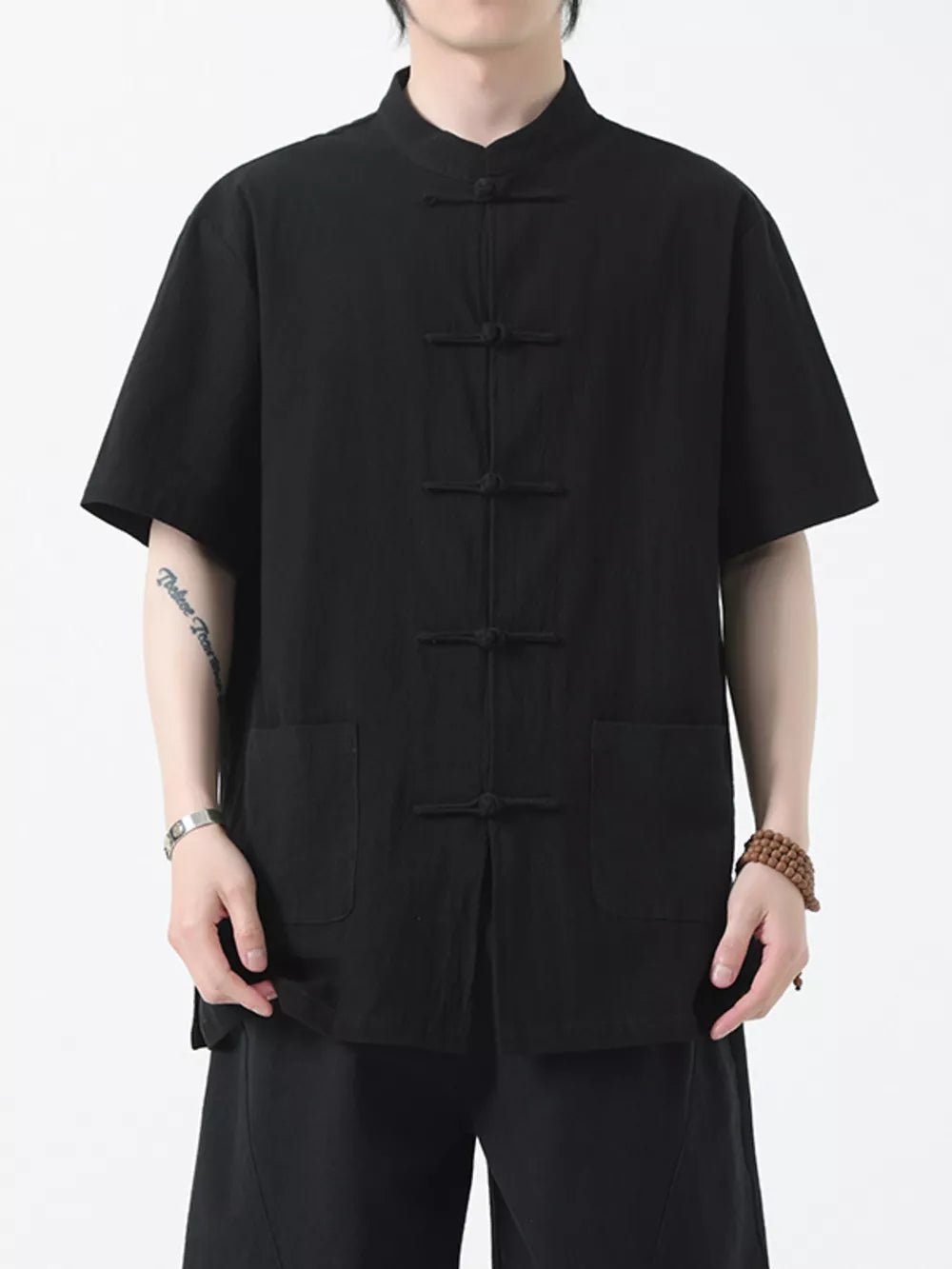 Black cotton short-sleeve shirt with mandarin collar and frog button closure.