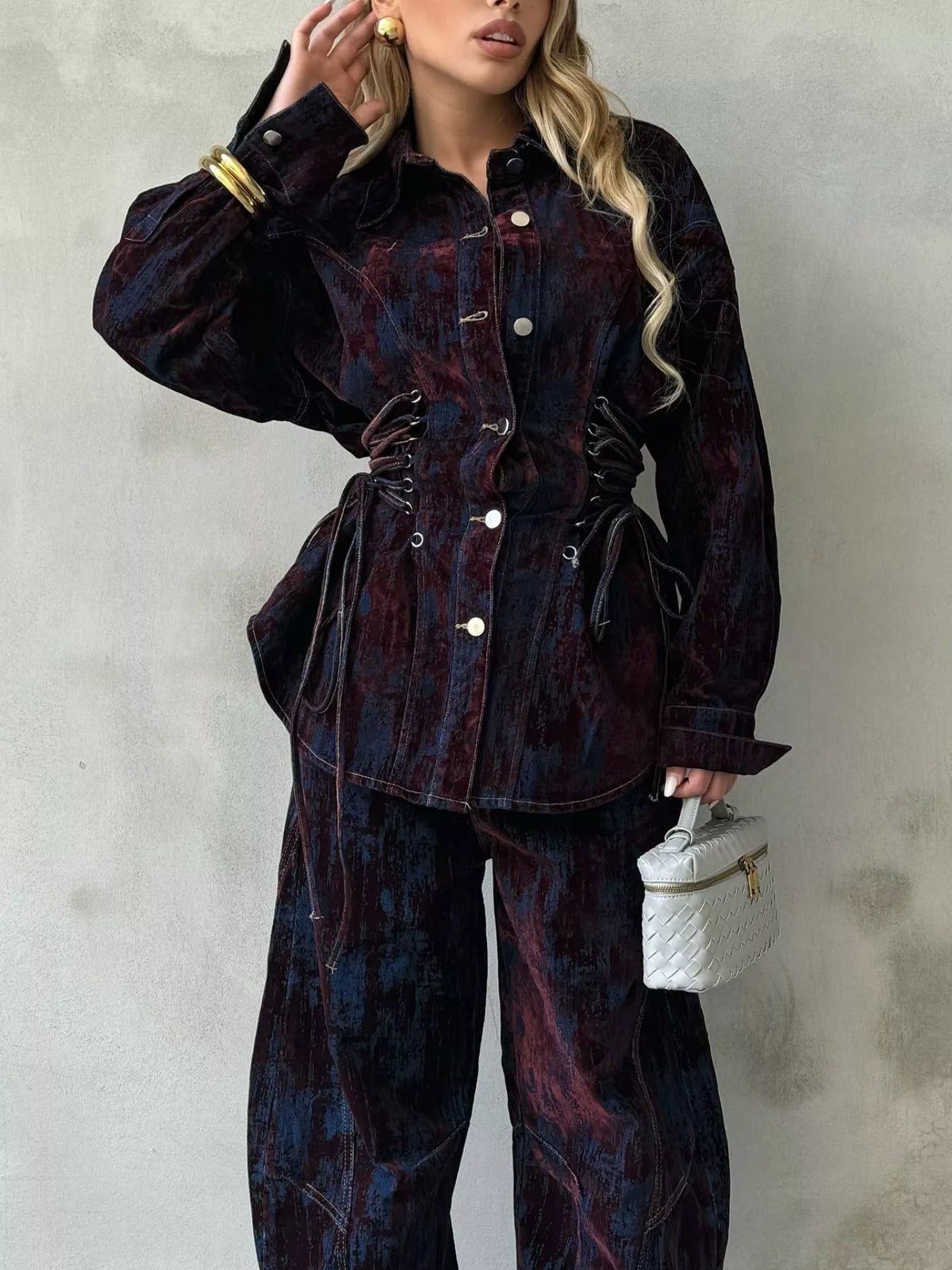 Lace-up denim jacket and pants set in burgundy and dark blue with a distressed pattern.