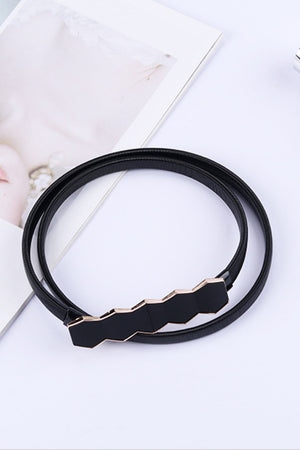 Black elastic belt with geometric black buckle and gold trim
