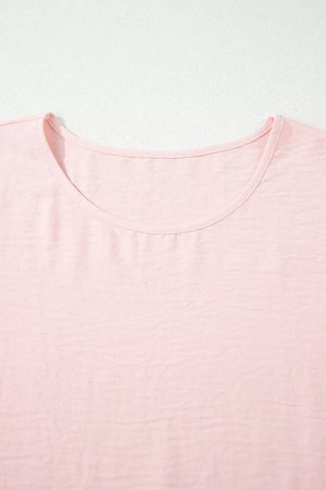 Blush pink polyester blouse with short sleeves and a ruffled neckline.