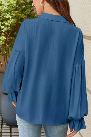 Blue long sleeve blouse with ruffled cuffs and a collared neckline.