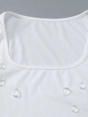 White ribbed square neck tank top with scattered rhinestone embellishments.