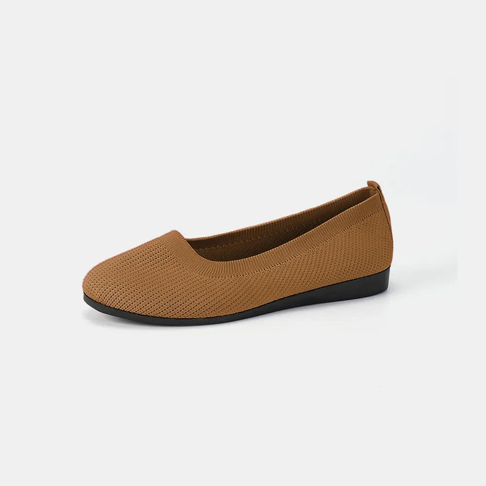 Textured knit slip-on flats in caramel with a black sole.