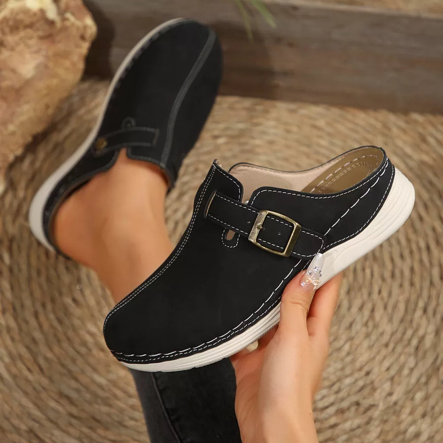 Black buckle accent round-toe slip-on flats with contrast stitching.