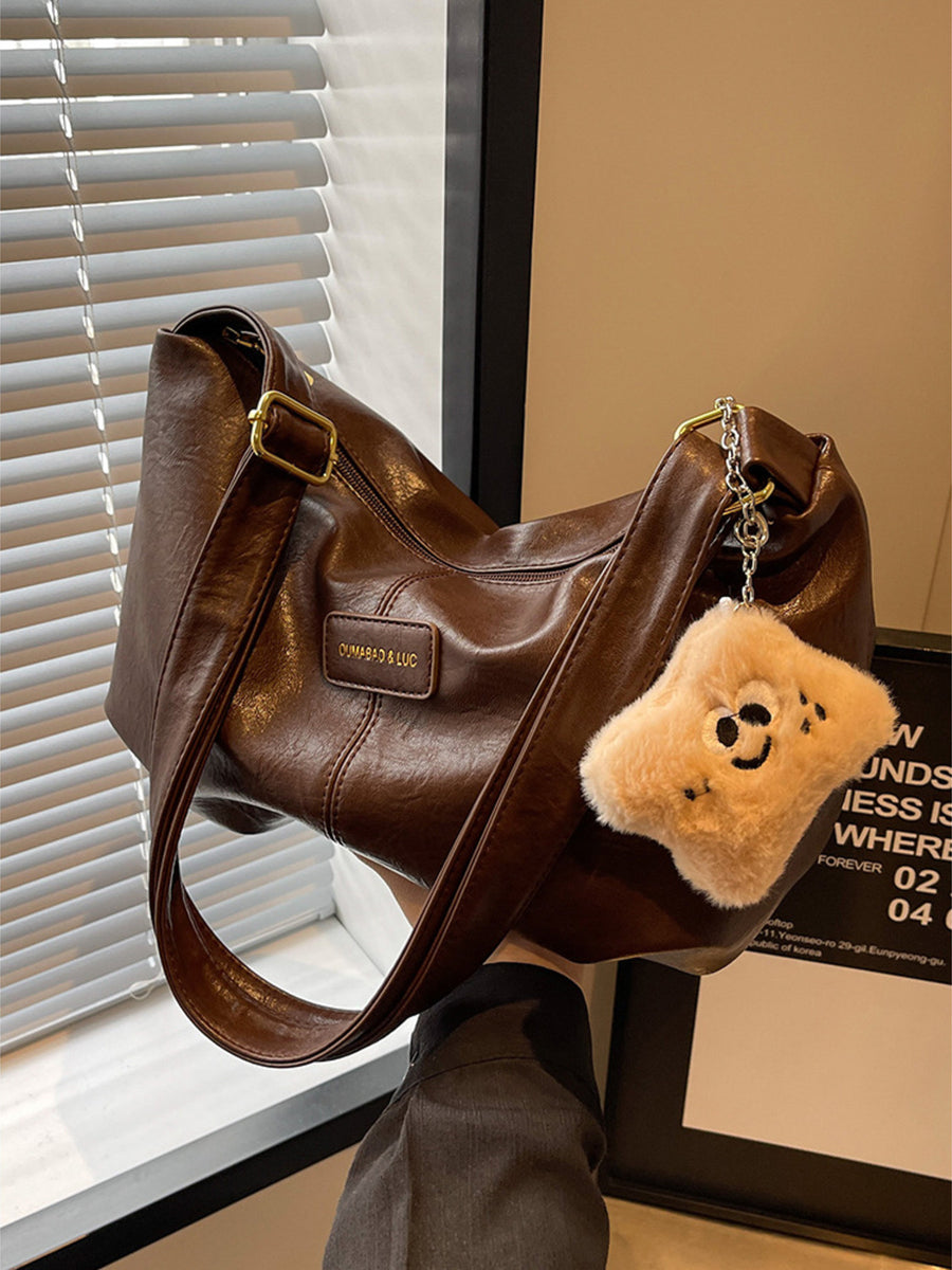 Brown pu leather crossbody bag with chain detail and fuzzy charm