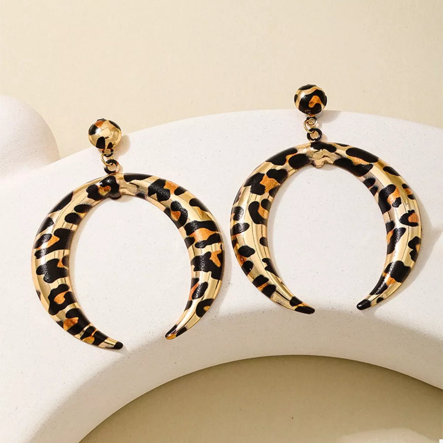 Gold crescent dangle earrings with leopard print pattern