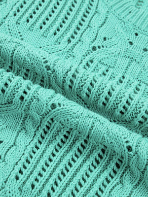 Pointelle knit sweater in mint green with cable and openwork details.