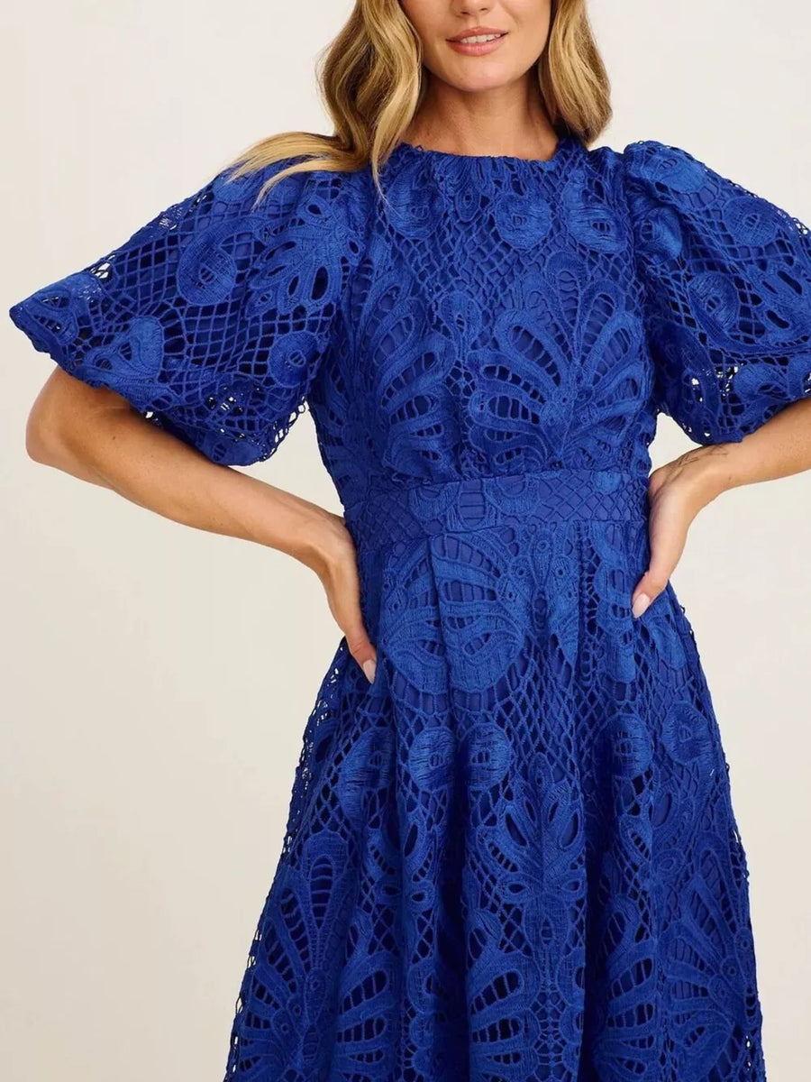 Blue lace midi dress with puff sleeves and intricate cutout pattern.