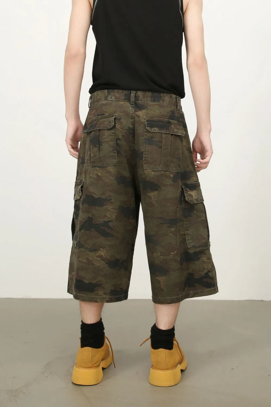 Camo culotte cargo shorts in green camouflage with multiple pockets.