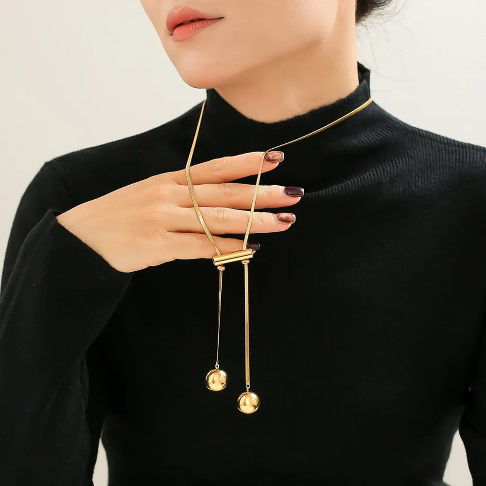 Gold lariat necklace with sphere drops and bar detail, 18K gold-plated.