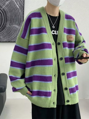 Oversized green striped V-neck cardigan with buttoned front and a small patch detail.