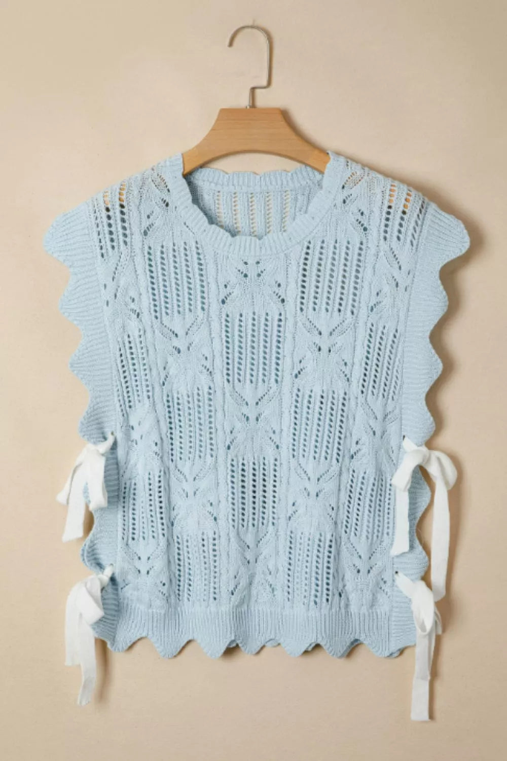 Light blue cable-knit openwork cotton blend top with cap sleeves and tie details.