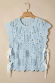 Light blue cable-knit openwork cotton blend top with cap sleeves and tie details.