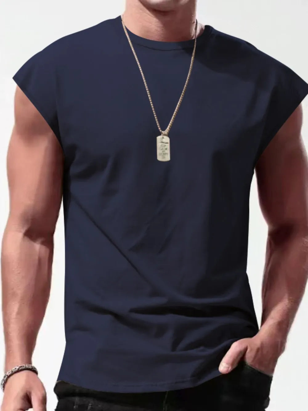 Navy muscle fit sleeveless tee with wide shoulders, crew neck, worn by a man with a dog tag necklace.