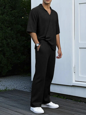 Black ribbed knit short sleeve collared shirt and matching wide leg pants set.