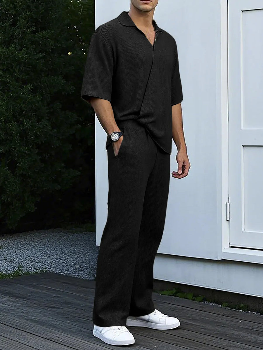 Black ribbed knit short sleeve collared shirt and matching wide leg pants set.