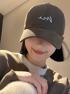 Grey cotton baseball cap with white embroidered logo and curved brim