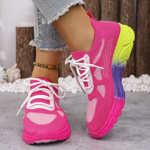 Breathable mesh lace-up sneakers in pink with a gradient sole of yellow, purple, and pink.