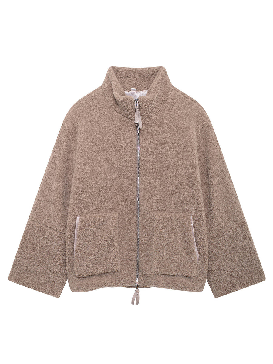 Tan sherpa jacket with stand collar, zip front, and two patch pockets.
