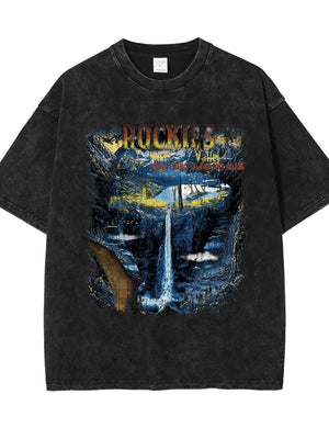 Black vintage wash t-shirt with a graphic of a waterfall in the Rockies valley.