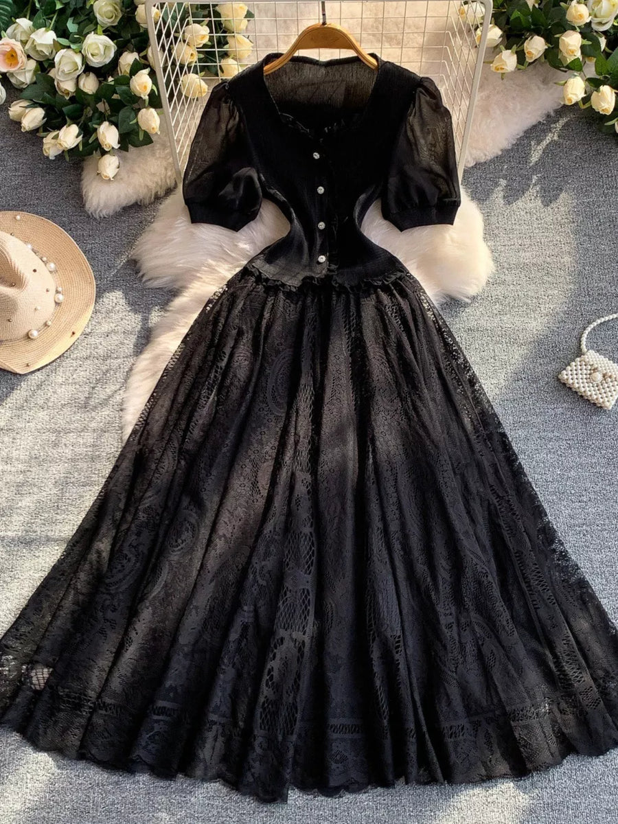Black lace-embellished puff sleeve dress with button front and full lace skirt.