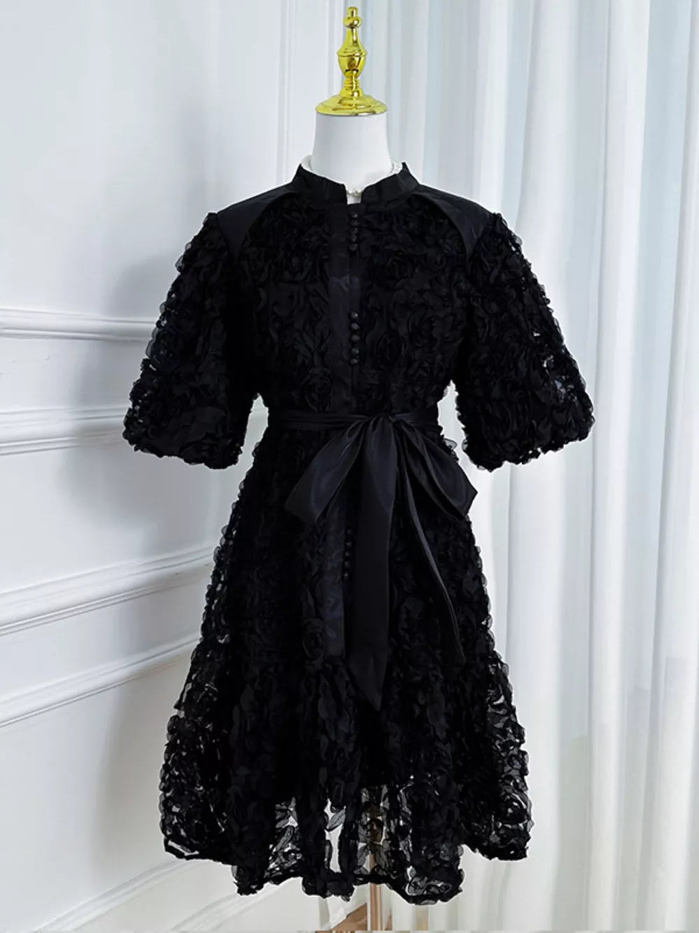 Black floral puff sleeve dress with button-down front and tie waist.