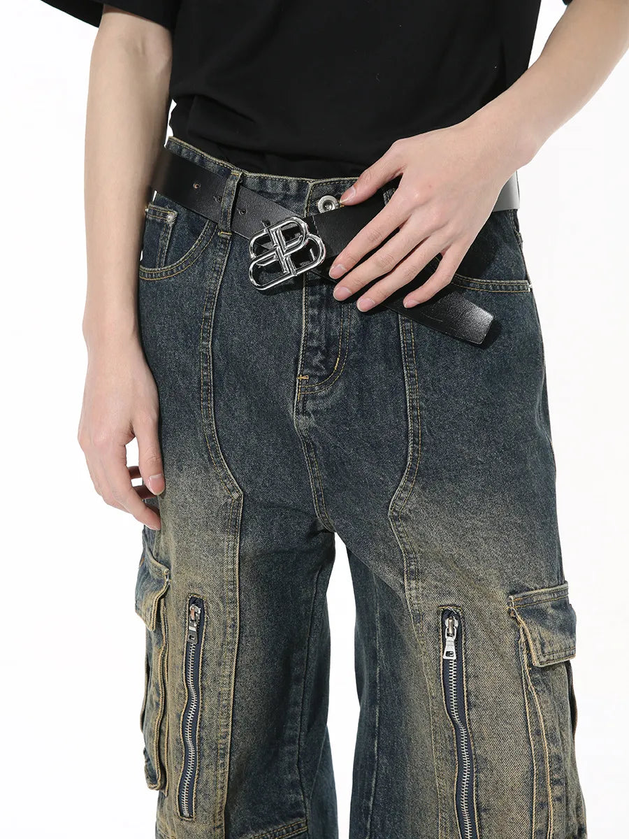 Dark distressed wide-leg cargo jeans with zippered pockets and a statement belt.
