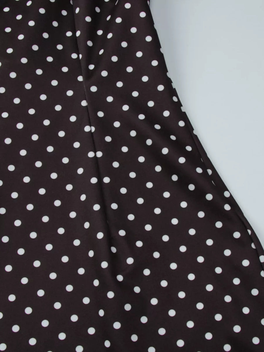 Brown polka dot mini dress with white dots and a cut-out detail.